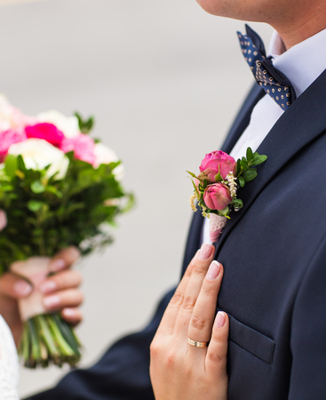 Bride and groom on their wedding day outdoors.の写真素材
