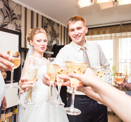 Bride and groom holding wedding champagne glasses.の写真素材