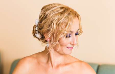 beautiful stylish bride getting ready in the morning in the roomの写真素材