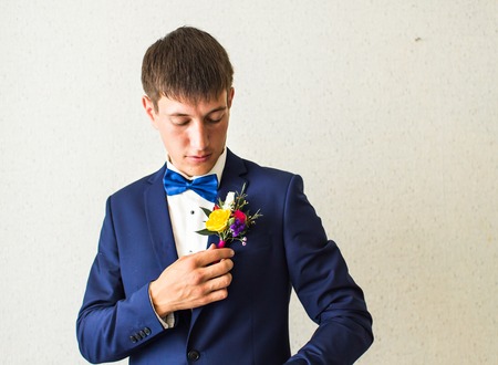 Wonderful wedding boutonniere on a costume of groom.