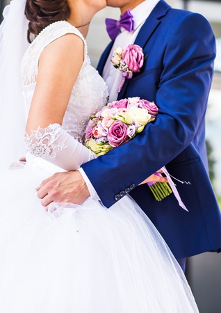 Bride and groom on their wedding day outdoors.の写真素材