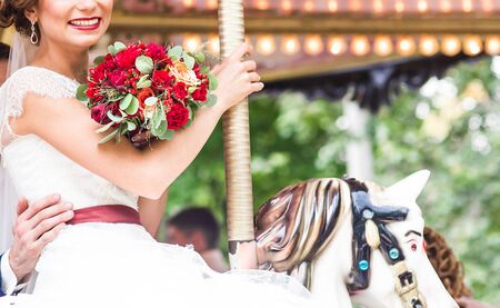 Bride and groom on carousel. Wedding dayの写真素材