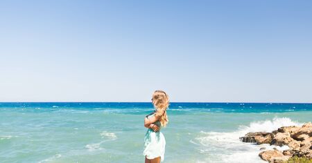 Young beautiful woman walking on the beachの写真素材