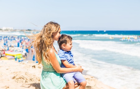 Portrait of happy mother and son at sea, outdoor.の写真素材
