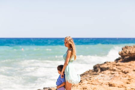 Portrait of happy mother and son at sea, outdoor.の写真素材