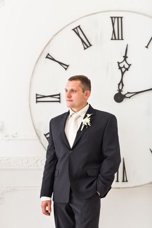 Businessman with a big clock. Time for work concept.
