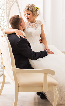 Young wedding couple enjoying romantic moments indoorsの写真素材