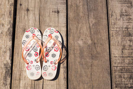 Flip flop on wooden background. relaxation and summer conceptの写真素材