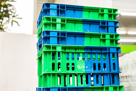 Pile of Plastic Pallets of Blue And Gray Color Stacked Beside A Store.の写真素材