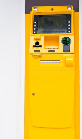 big yellow ATM machine in the street