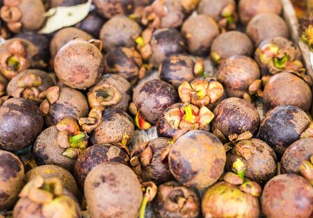 Fresh mangosteen for sale at an outdoor marketの写真素材