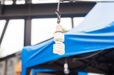 Energy saving light bulb glowing on backgroundの写真素材