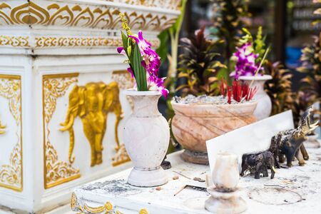 Outdoor spirit house in Thailand. spirit house in thailand with garland and some wreathes, joss...
