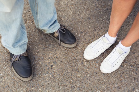 Closeup of male and female legs during a date.の写真素材