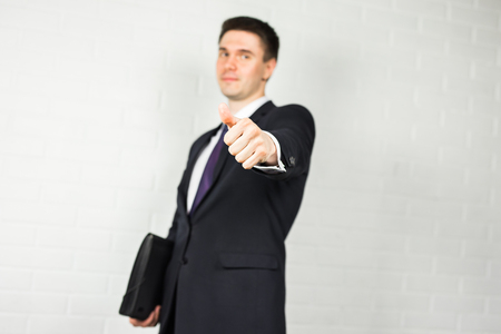 business and office concept - handsome buisnessman showing thumbs up.の写真素材