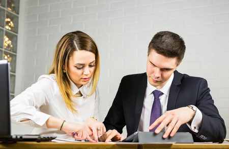 Male and female office workers. Image of two successful business partners working at meeting in officeの写真素材