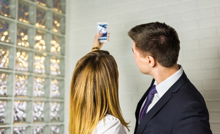 Two successful business people taking a happy Selfie in the officeの写真素材