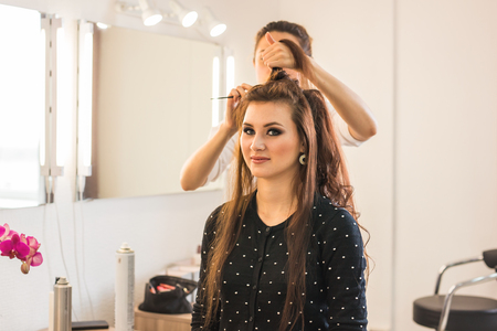 Woman with long hair in beauty salon, isolated on whiteの写真素材