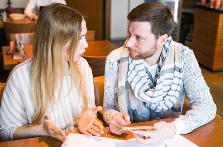 Man and woman arguing about home financesの写真素材