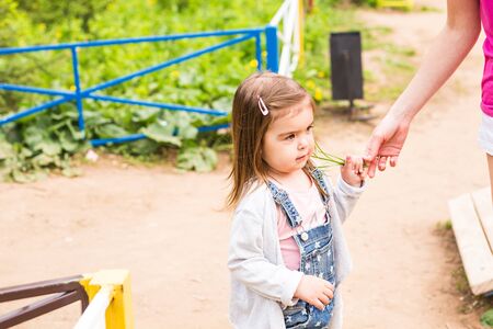 little baby girl on the summer playground