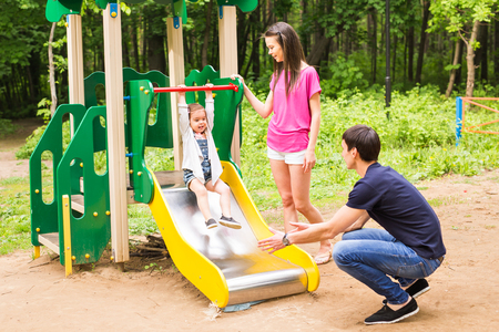 A girl playing at the playground in the parkの写真素材
