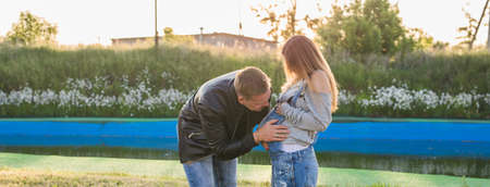 Happy smiling future parents on the walk in autumn park.の写真素材