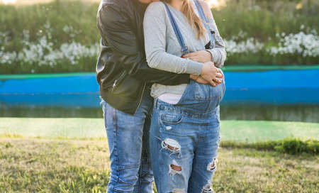 Happy smiling future parents on the walk in autumn park.の写真素材