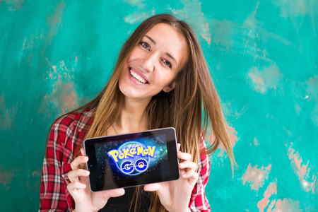 Ufa, Russia. - July 29: Woman show the tablet with Pokemon Go logoのeditorial素材