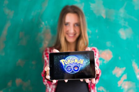 Ufa, Russia. - July 29: Woman show the tablet with Pokemon Go logoのeditorial素材