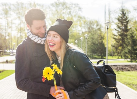 Couple with flower at the park. Outdoor.の写真素材