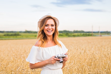 female photographer in the field with a camera taking pictures.
