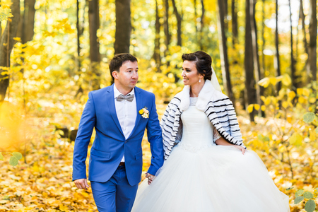 bride and groom in autumn park. Autumn weddingの写真素材