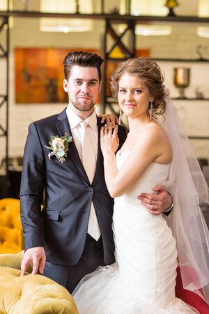 Charming bride and groom on their wedding celebration in a luxurious restaurant.の写真素材