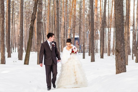 Winter wedding. Beautiful young couple bride and groom.の写真素材