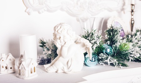 Christmas angel figurine on white wooden tableの写真素材