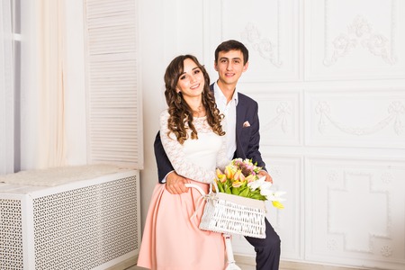 fashion photo of elegant loving couple posing at studio with classic interior near the bicycle.の写真素材