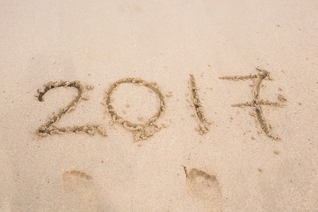 New Year 2017 is coming concept - inscription 2017 on a beach sand.の写真素材
