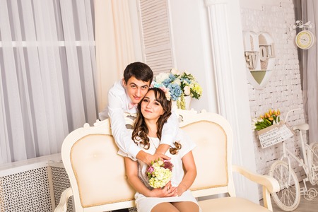 Close up portrait of young attractive romantic couple hugging and kissing. Love and relationships lifestyle, interior bedroomの写真素材