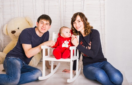 Parents kissing newborn baby. Family love concept