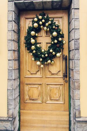 Christmas wreath with baubles and cones on a doorの写真素材