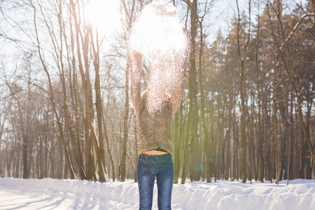 Beauty Girl Blowing Snow in frosty winter Park. Outdoors. Flying Snowflakesの写真素材