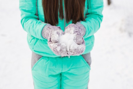 Closeup on woman hand in snowed gloves.の写真素材