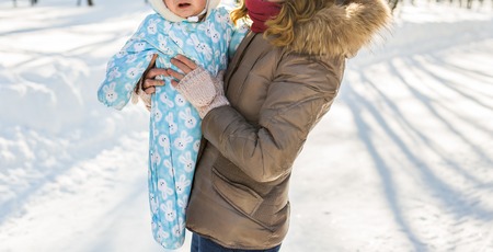 Portrait of happy mother and baby in winter parkの写真素材