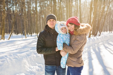 happy young family spending time outdoor in winter.の写真素材