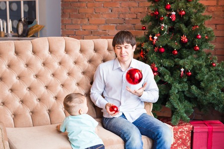 Father and son on Christmas interior background.の写真素材