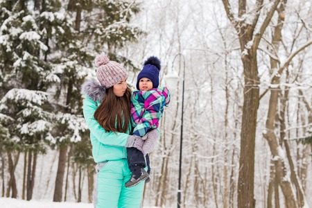 Happy family. Mother and child girl on a winter walk in natureの写真素材