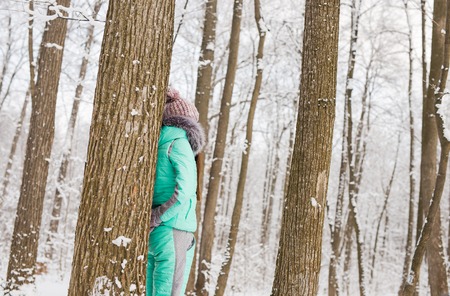 Portrait of a cute brunette in a frosty parkの写真素材