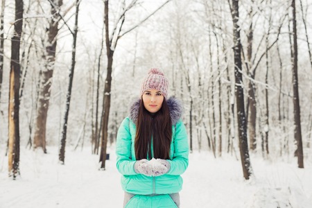 Portrait of a cute brunette in a frosty parkの写真素材