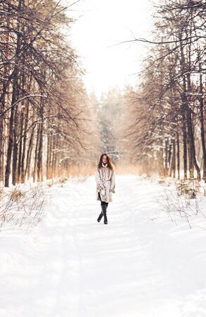 Young pretty Girl walking in snowy natureの写真素材