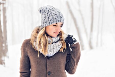 Attractive young woman in wintertime outdoor. Snow and cold.の写真素材